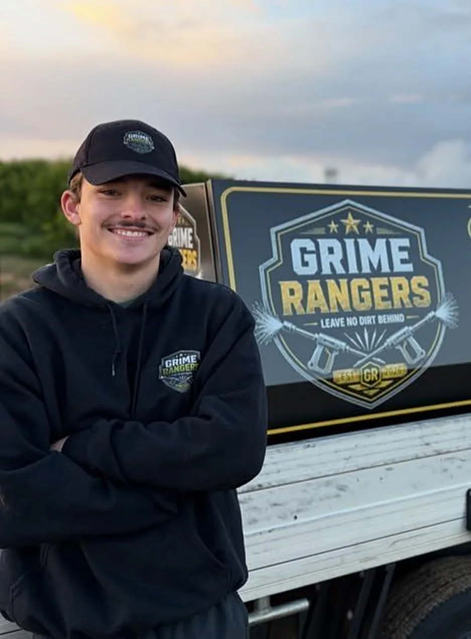Fin Marks, Head Ranger, in a Grime Rangers cap and hoodie beside his ute